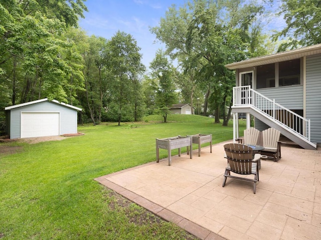 15015 Vermillion Cir NE, Ham Lake, MN 55304 - view of grassy yard with a patio, an outdoor structure, stairs, a garage, and an outdoor fire pit