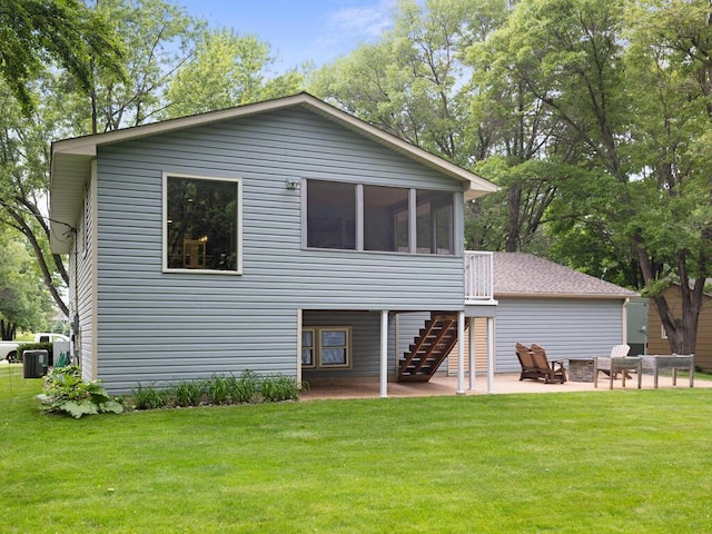 15015 Vermillion Cir NE, Ham Lake, MN 55304 - back of house featuring a patio area, stairway, a sunroom, and a lawn