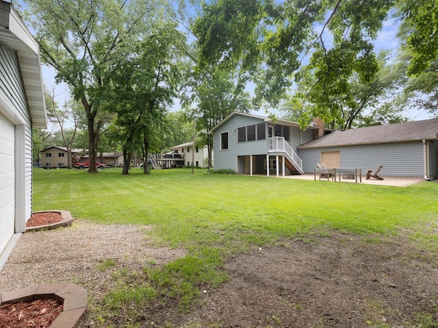 15015 Vermillion Cir NE, Ham Lake, MN 55304 - view of grassy yard with a sunroom, a patio, and stairway