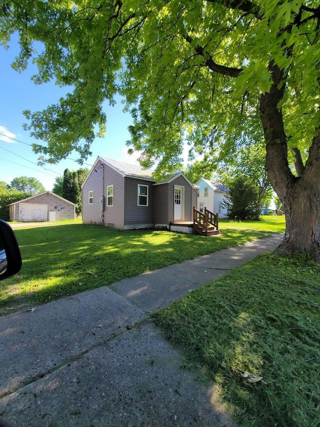 view of front of house featuring a garage, a front yard, and a deck