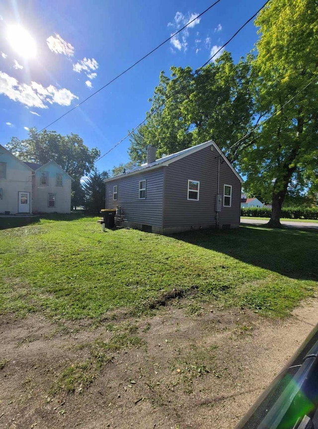 view of side of home featuring a lawn