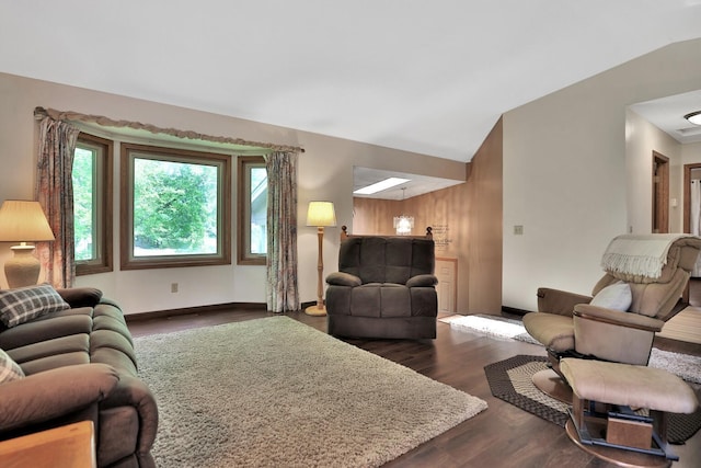 living area featuring baseboards, dark wood-type flooring, and vaulted ceiling