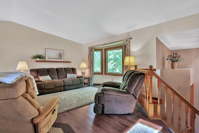 living area with wood finished floors and vaulted ceiling