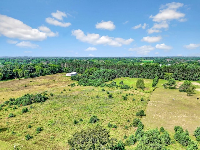 aerial view featuring a wooded view