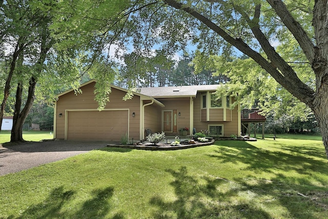 view of front facade featuring a front lawn, a garage, driveway, and a wooden deck