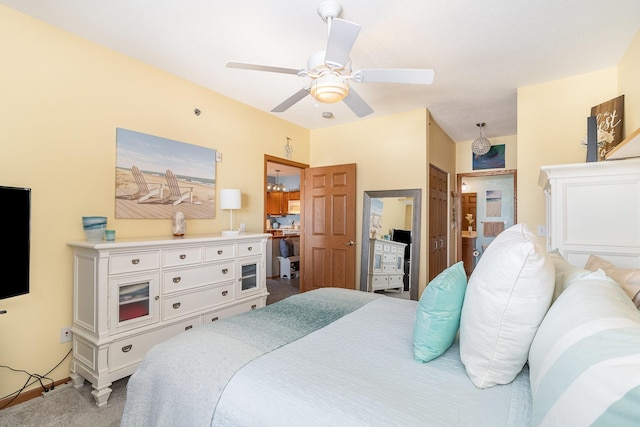 carpeted bedroom featuring ceiling fan and ensuite bathroom