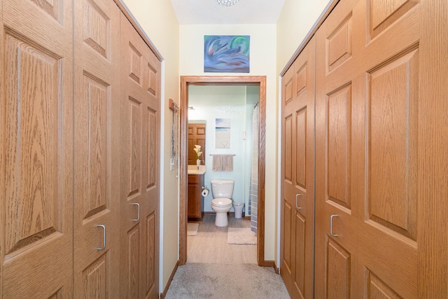 hall featuring light colored carpet