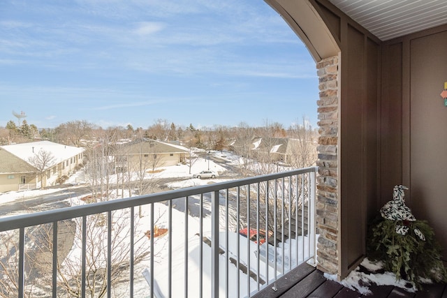 snow covered back of property with a residential view