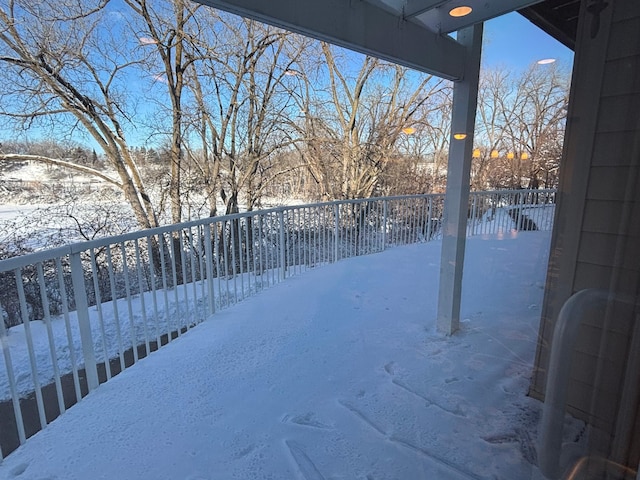 yard covered in snow featuring fence