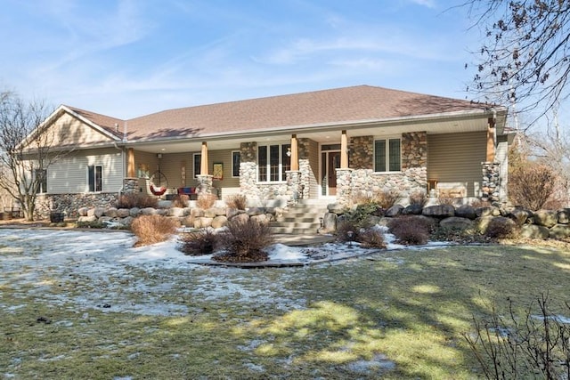 view of front of property featuring stone siding, a porch, and a shingled roof