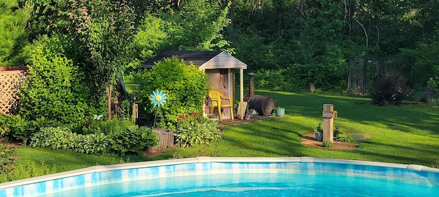 outdoor pool with an outdoor structure and a yard