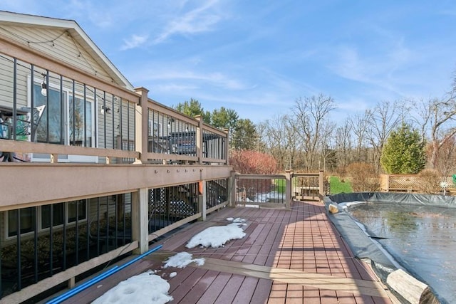 wooden terrace with a covered pool