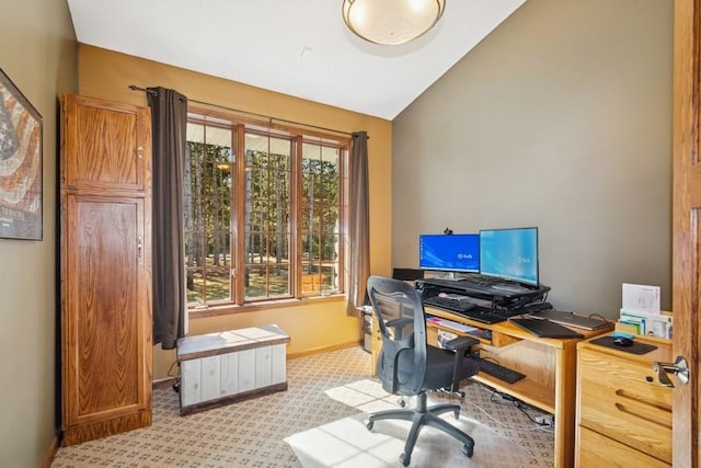 office featuring baseboards, light colored carpet, and vaulted ceiling