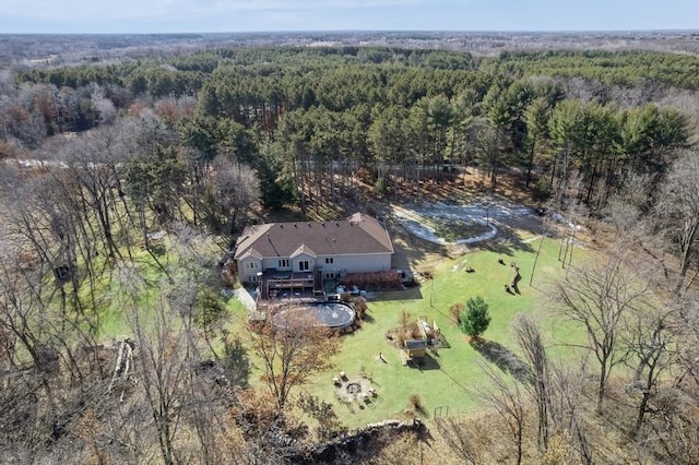 bird's eye view with a wooded view