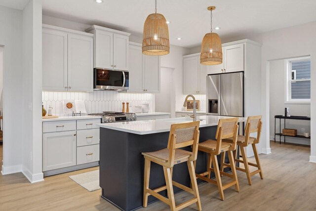 4640 Meadowview Ln, Minnetrista, MN 55331 - kitchen featuring appliances with stainless steel finishes, recessed lighting, light wood finished floors, light countertops, and backsplash