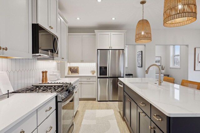 4640 Meadowview Ln, Minnetrista, MN 55331 - kitchen with appliances with stainless steel finishes, light wood finished floors, recessed lighting, tasteful backsplash, and white cabinetry