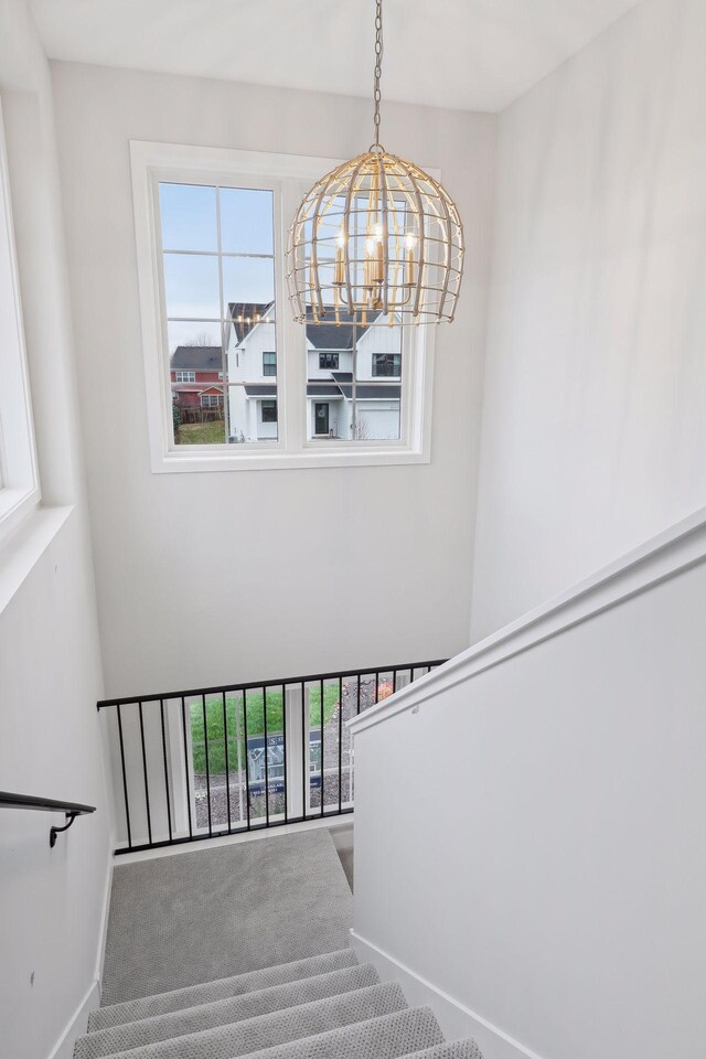 4640 Meadowview Ln, Minnetrista, MN 55331 - stairway featuring a chandelier, carpet flooring, healthy amount of natural light, and a high ceiling