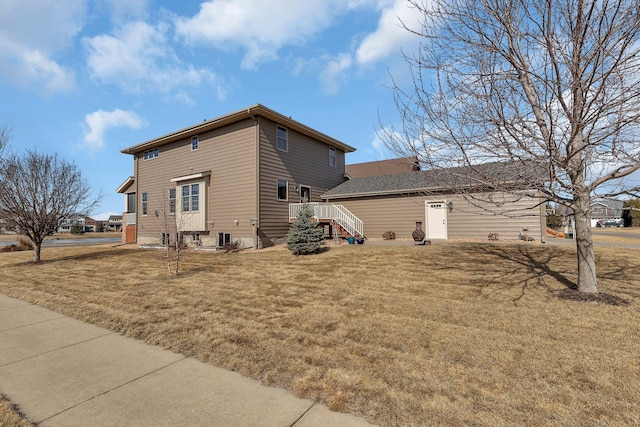 view of home's exterior with central air condition unit and a lawn