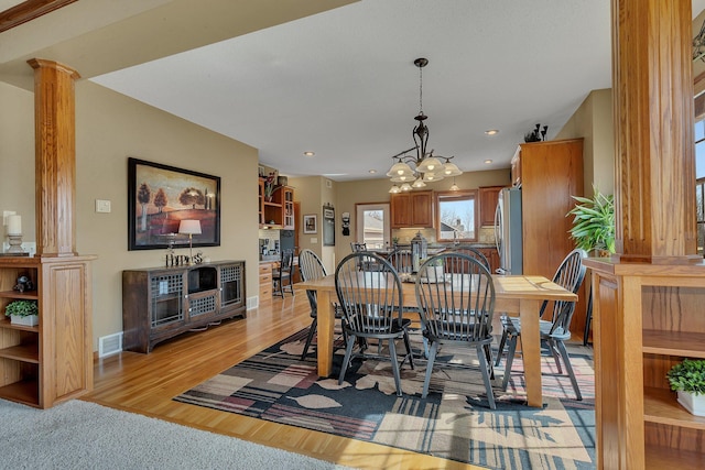 dining space featuring visible vents, ornate columns, baseboards, recessed lighting, and light wood-type flooring