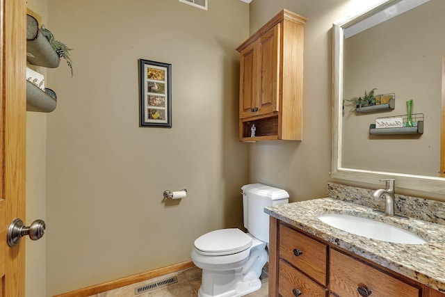 bathroom featuring vanity, toilet, baseboards, and visible vents