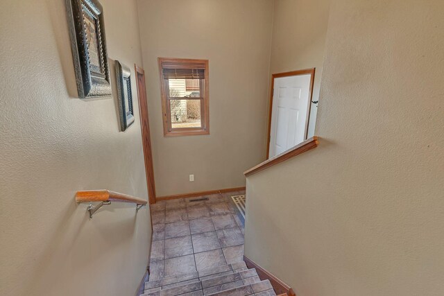 staircase featuring visible vents and baseboards