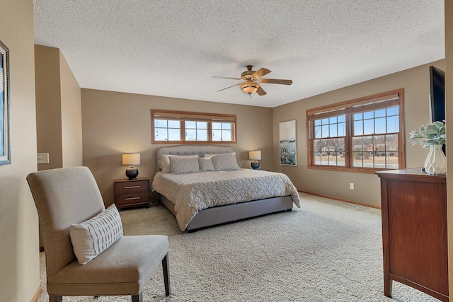 bedroom with baseboards, light carpet, a textured ceiling, and ceiling fan