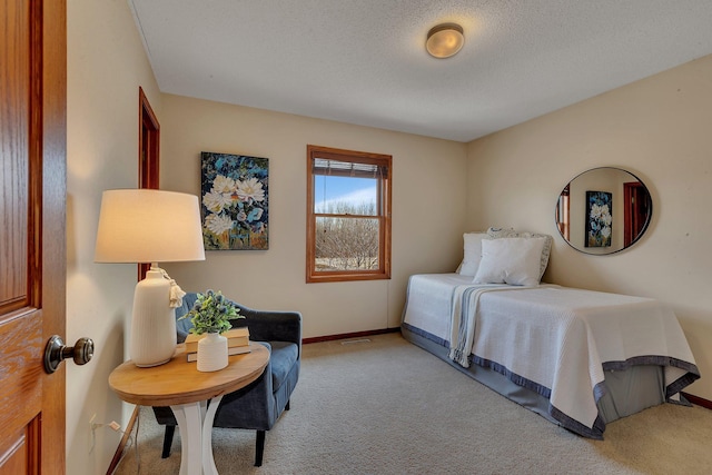 bedroom featuring baseboards, a textured ceiling, and carpet flooring