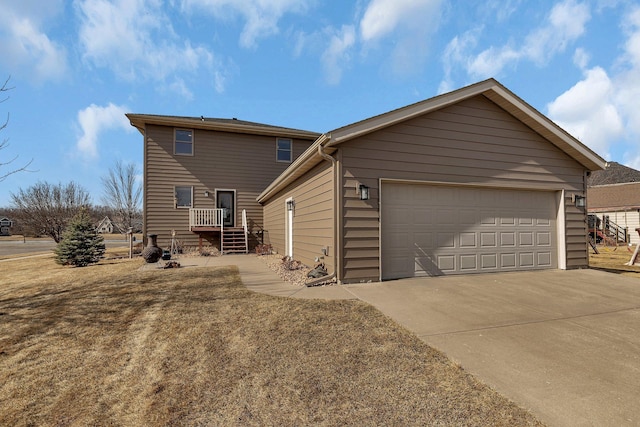 view of home's exterior featuring an attached garage and driveway