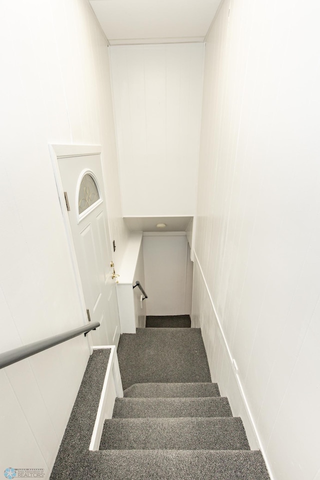 stairway with a decorative wall