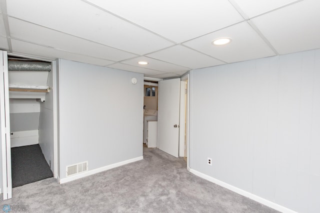 finished basement with a drop ceiling, recessed lighting, carpet floors, visible vents, and washer / dryer