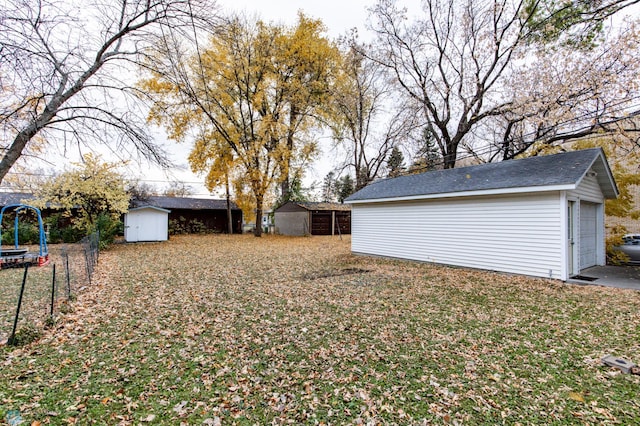 view of yard featuring a shed and an outbuilding