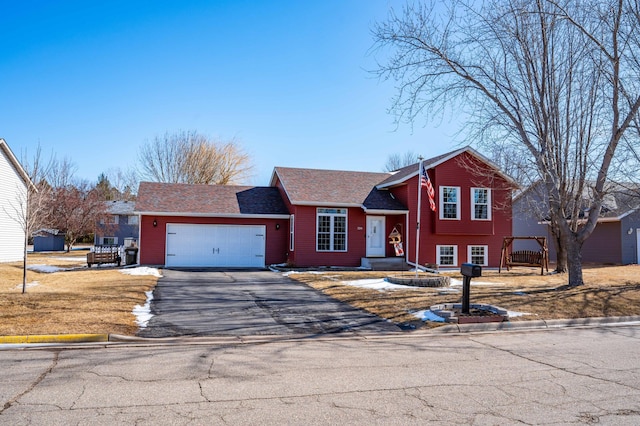 tri-level home with driveway and an attached garage