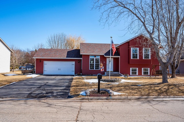 split level home featuring driveway and an attached garage