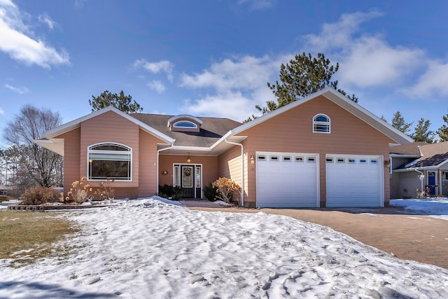 single story home featuring an attached garage and driveway