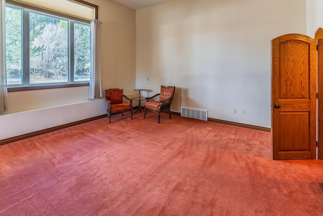 sitting room with baseboards, visible vents, and carpet flooring