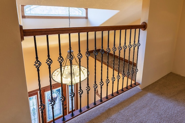 staircase with a skylight and carpet