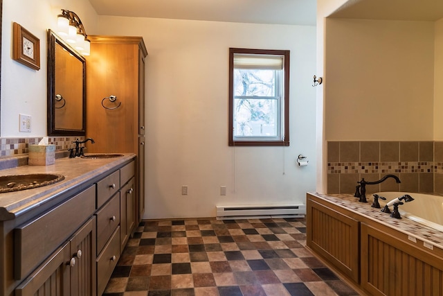 full bathroom featuring a garden tub, double vanity, a baseboard radiator, a sink, and tile patterned floors