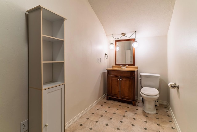 bathroom featuring baseboards, vanity, toilet, and tile patterned floors