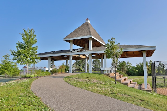 view of community with a yard, fence, and a gazebo