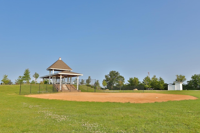 surrounding community with a gazebo, a lawn, and fence