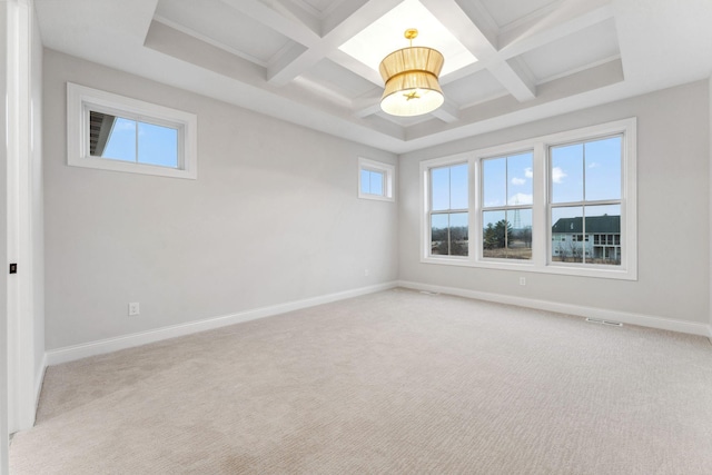 empty room featuring light carpet, coffered ceiling, and baseboards