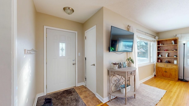 entryway with light wood-style floors and baseboards