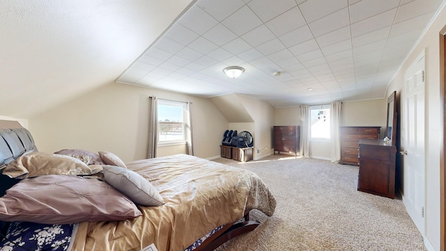 bedroom with multiple windows, baseboards, vaulted ceiling, and carpet flooring