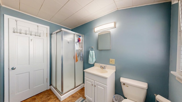 bathroom with crown molding, toilet, a shower stall, and vanity