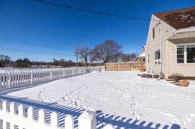 yard covered in snow featuring a fenced backyard