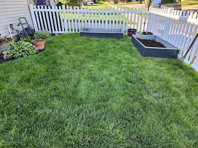 view of yard featuring a garden and fence