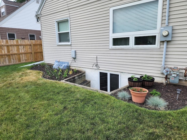 exterior space with fence and a yard