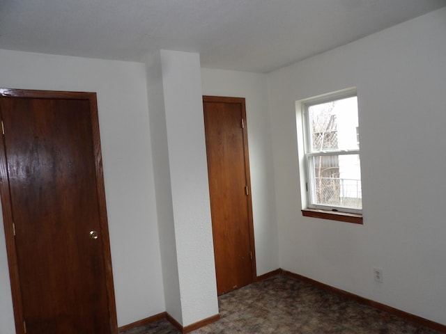 unfurnished bedroom with baseboards, a closet, and carpet flooring