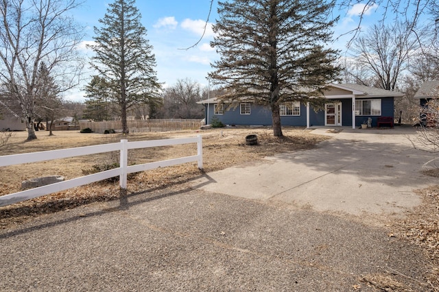 view of front of home with a fenced front yard and driveway