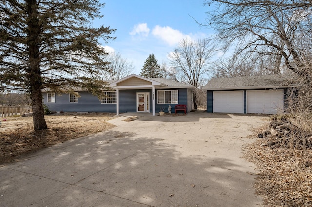 view of front of house with crawl space, a detached garage, an outdoor structure, and roof with shingles